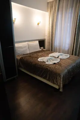 a bedroom with a bed with two towels on it at Pearl Hotel İstanbul in Istanbul