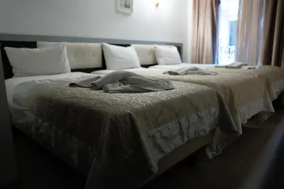 two beds in a bedroom with a blanket on them at Pearl Hotel İstanbul in Istanbul