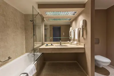 a bathroom with a sink and a tub and a toilet at Kaya Uludag in Uludag