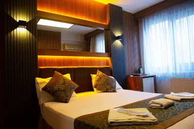 a hotel room with a bed and a window at Emirtimes Hotel Kadıköy in Istanbul