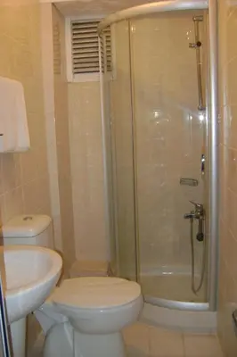 a bathroom with a shower and a toilet and a sink at Hotel Ay in Istanbul