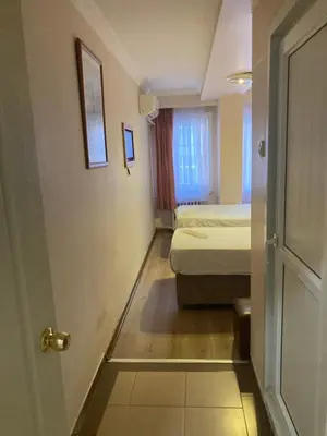 a room with a bedroom with a bed and a door at Hotel Ay in Istanbul