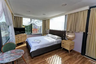 a hotel room with a bed and a television at Romantic Mansion in Istanbul