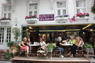 a group of women sitting at tables outside a restaurant at Romantic Mansion in Istanbul