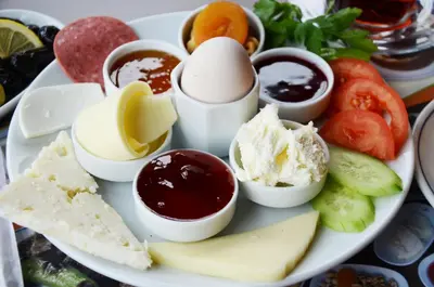 a plate of food with eggs and jam and cheese at Romantic Mansion in Istanbul