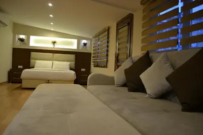 a living room with a couch and a bed at Seven Days Hotel - İstanbul in Istanbul