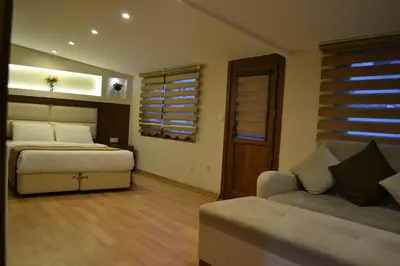 a bedroom with a bed and a couch at Seven Days Hotel - İstanbul in Istanbul