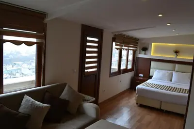 a hotel room with a bed and a couch at Seven Days Hotel - İstanbul in Istanbul