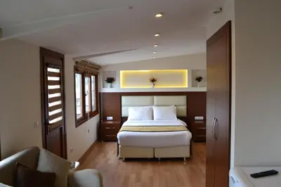 a bedroom with a bed and a couch at Seven Days Hotel - İstanbul in Istanbul