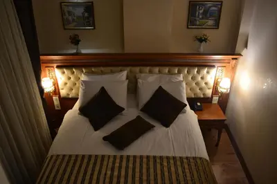 a bedroom with a large bed with two pillows at Seven Days Hotel - İstanbul in Istanbul