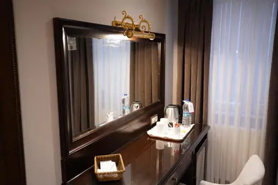 a bathroom with a large mirror and a sink at Amethyst Hotel in Istanbul