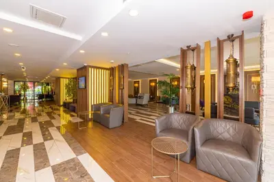 a lobby with couches and tables in a building at Land Park Hotel in Istanbul