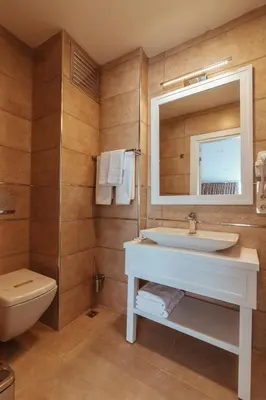 a bathroom with a sink and a toilet and a mirror at Istanroom by Keo in Istanbul