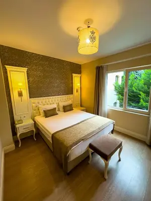 a bedroom with a large bed and a window at Sarnic Premier Hotel in Istanbul