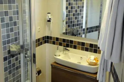 a bathroom with a sink and a mirror at Sarnic Premier Hotel in Istanbul