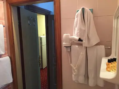a bathroom with a phone hanging on the wall at Paris Hotel in Istanbul
