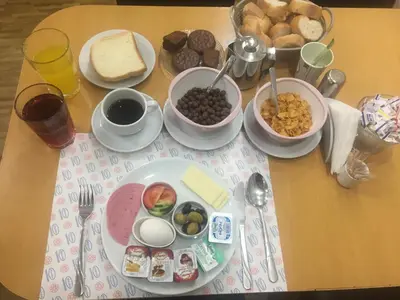 a table topped with plates and bowls of breakfast foods at Paris Hotel in Istanbul