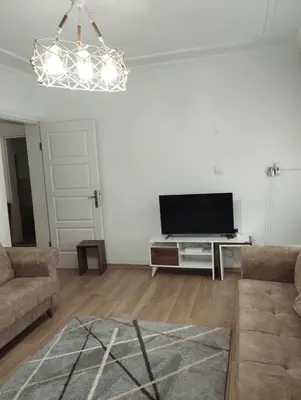 a living room with a flat screen tv and a couch at Yıldız Pansiyon in Sapanca