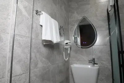 a bathroom with a shower and a sink and a mirror at Rays Hotel - Bakirkoy Istanbul City Center in Istanbul