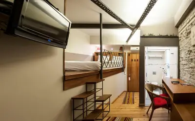 a small room with a bunk bed and a desk at Peradays in Istanbul
