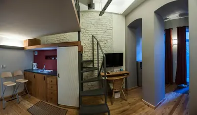 a living room with a spiral staircase and a kitchen at Peradays in Istanbul