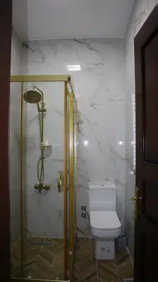 a bathroom with a toilet and a glass shower at Blue Eye Suites in Istanbul