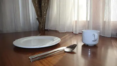 a table with a plate and a cup and a spoon at Blue Eye Suites in Istanbul