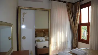 a mirror in a room with a bed and a bedroom at Blue Eye Suites in Istanbul