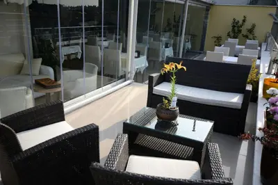 a patio with two chairs and a table with a plant on it at Khalkedon Hotel Istanbul in Istanbul