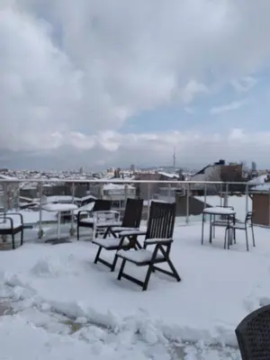 a patio with chairs and tables in the snow at Khalkedon Hotel Istanbul in Istanbul