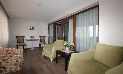 a living room with chairs and a couch and a table at Belle Maison Hotel&Residence in Istanbul