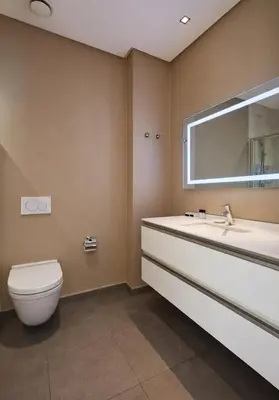 a bathroom with a toilet and a sink and a mirror at Fraser Place Anthill Istanbul in Istanbul
