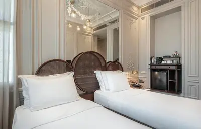 a bedroom with two beds with white pillows and a mirror at The Stay Bosphorus in Istanbul