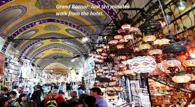 a crowd of people walking through a market with lights at Ancient Town Hotel in Istanbul