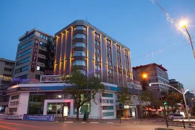 a tall building on a city street at night at Kervansaray Bursa City Hotel in Bursa