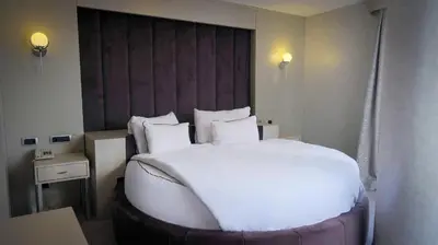 a large white bed in a hotel room at Kervansaray Bursa City Hotel in Bursa