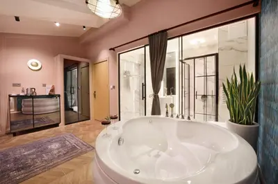 a large bathroom with a tub and a large window at Harbiye Residence in Istanbul