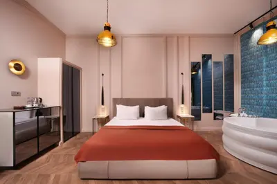 a bedroom with a bed and a tub and a sink at Harbiye Residence in Istanbul