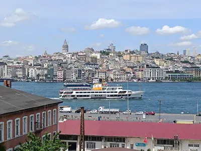 a large boat in the water near a city at Golden Horn Bosphorus Hotel in Istanbul