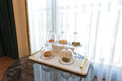 a table with four glass jars and plates of food at Golden Horn Bosphorus Hotel in Istanbul