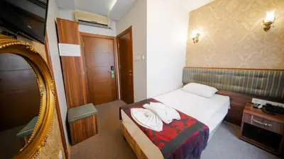 a hotel room with a bed and a mirror at Sahil Boutique Hotel in Istanbul