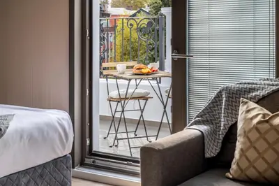 a room with a table and a balcony with a table and chair at Çırağan Apart Bosphorus in Istanbul