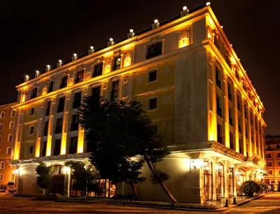 a large white building with lights on it at night at Deluxe Golden Horn Sultanahmet Hotel in Istanbul
