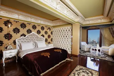 a bedroom with a bed and a chair and a window at Deluxe Golden Horn Sultanahmet Hotel in Istanbul