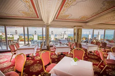 a dining room with tables and chairs and windows at Deluxe Golden Horn Sultanahmet Hotel in Istanbul