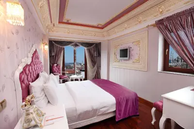 a bedroom with a white bed and a window at Deluxe Golden Horn Sultanahmet Hotel in Istanbul
