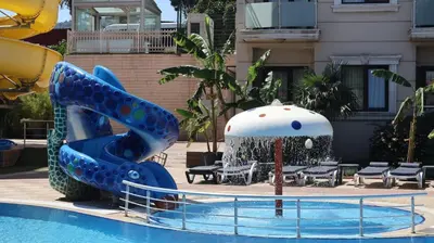 a blue water slide in a swimming pool at Elegance Resort Hotel & SPA Wellness-Aqua in Yalova