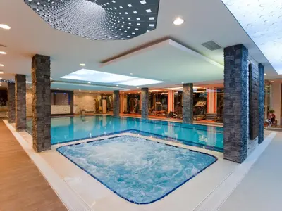 a large swimming pool in a building with a large swimming pool at Elegance Resort Hotel & SPA Wellness-Aqua in Yalova