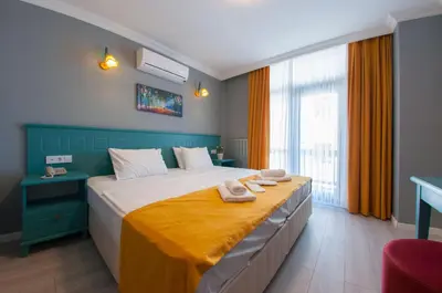 a bedroom with a large bed with towels on it at Room Room Motel in Sapanca