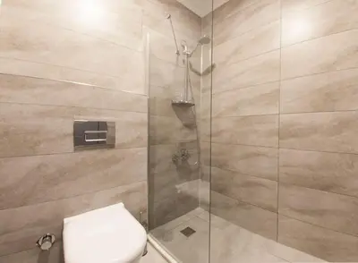 a bathroom with a toilet and a glass shower at Room Room Motel in Sapanca